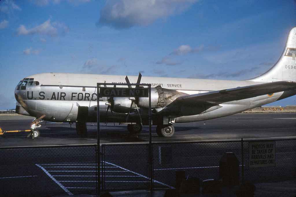 Looking good! A USAF MATS C-97 Boeing Startocruiser 0694 having just arrived either from the West Coast or the Far East. Here passenger door is open and she rests at Hickam's "Gate No 1" in this period early 1950s kodachrome view.