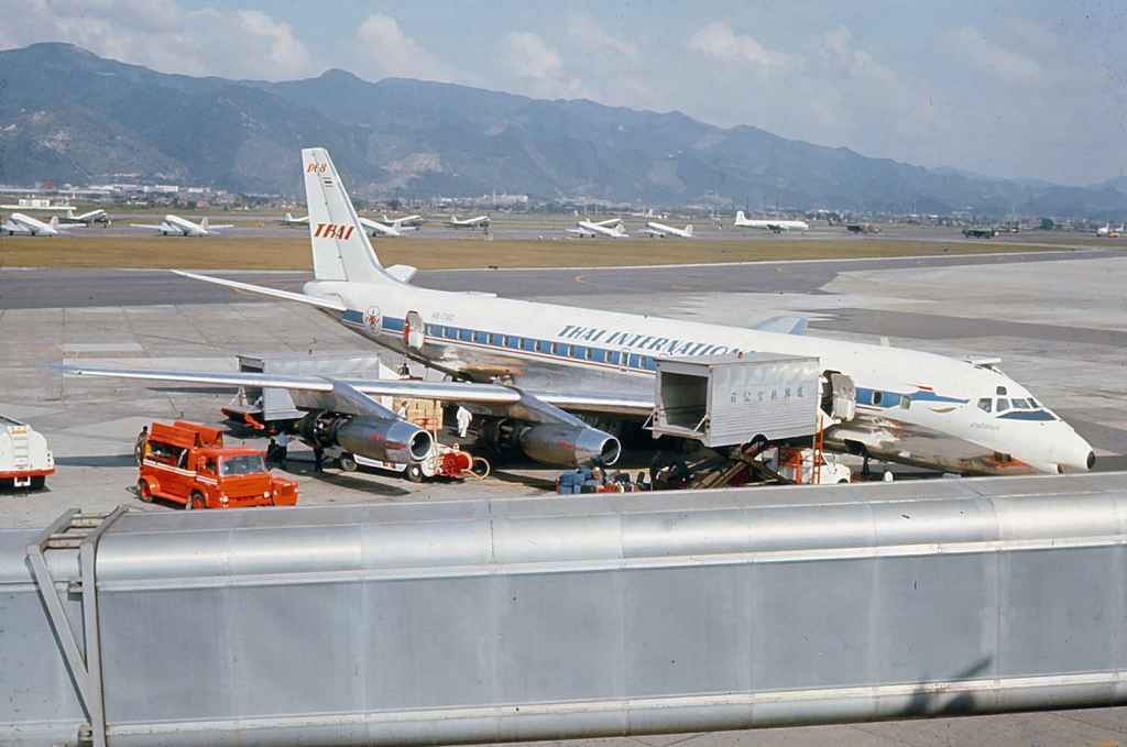 Thai International DC-8-30 HS-TGO operating a sked service Flying Tigers DC-8-63 N782FT operating a Vietnam War charter at Taipei Sung Shan airport circa 1971.