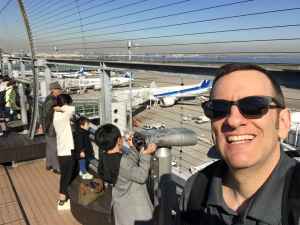 Henry Tenby on the obsdeck at Tokyo Haneda ANA Terminal 2 with Tokyo Bay in the background.
