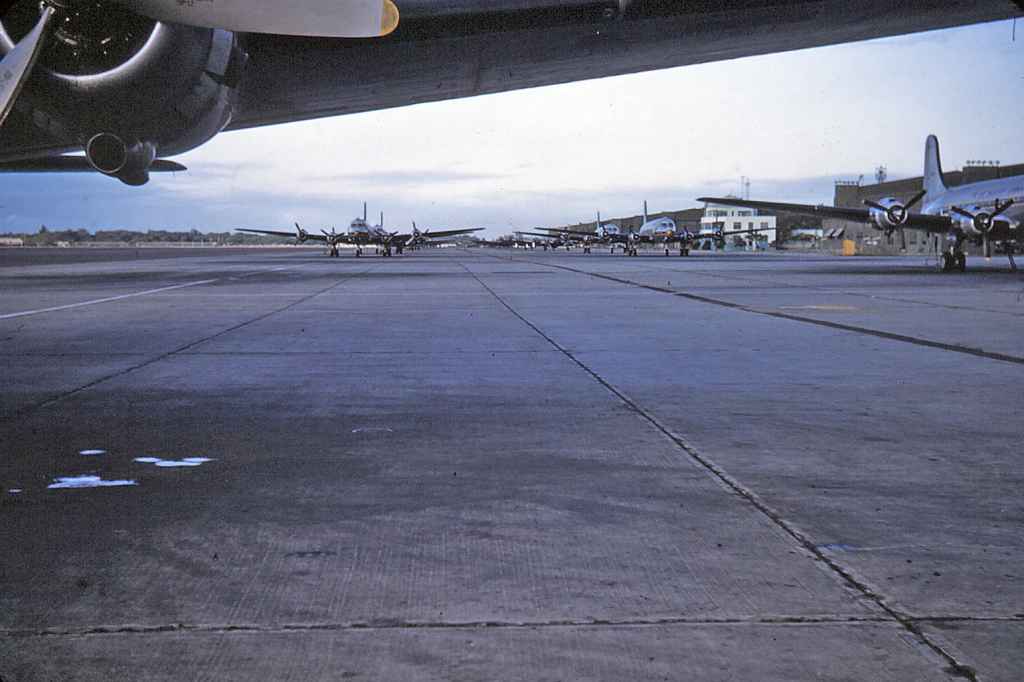 Another fine view of the Hickam AFB transient apron, which is teaming with Douglas C-54 Skymasters. Hundreds of these were built for the war effort, and after the war, the US military had a huge inventory, which were luckily still on strength and were able to support the supply efforts of the Berlin Airlift. It is possible this image taken at Hickam was taken before the Berlin Airlift, just based on the large number of locally stationed aircraft.