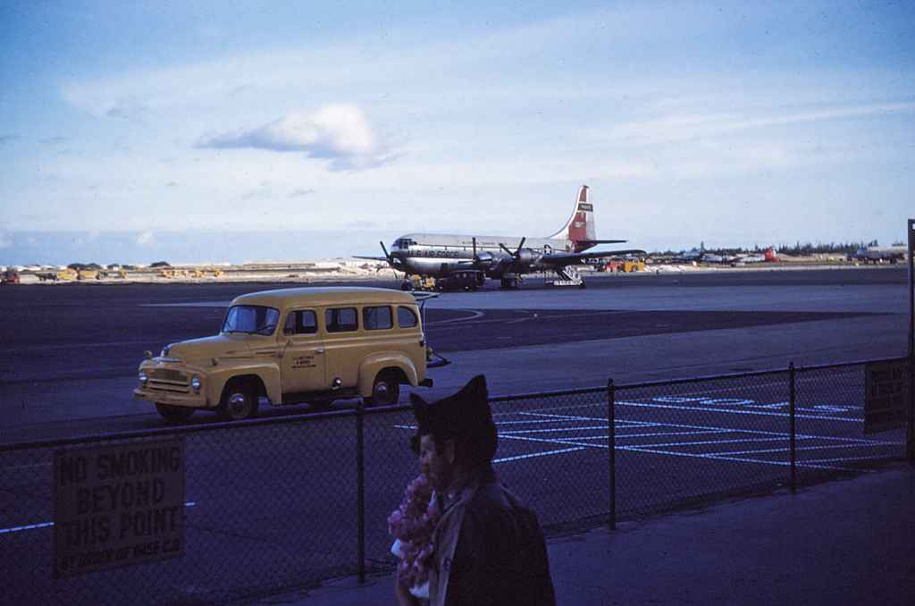 Hickam Air Force Base transient apron circa early 1950s. We have a Pacific based USAF MATS C-97 Stratocruiser, with a serviceman and his wife or girlfriend are seen in lower centre frame. The flower lei on the woman is a Hawaiian tradition that dates back generations.