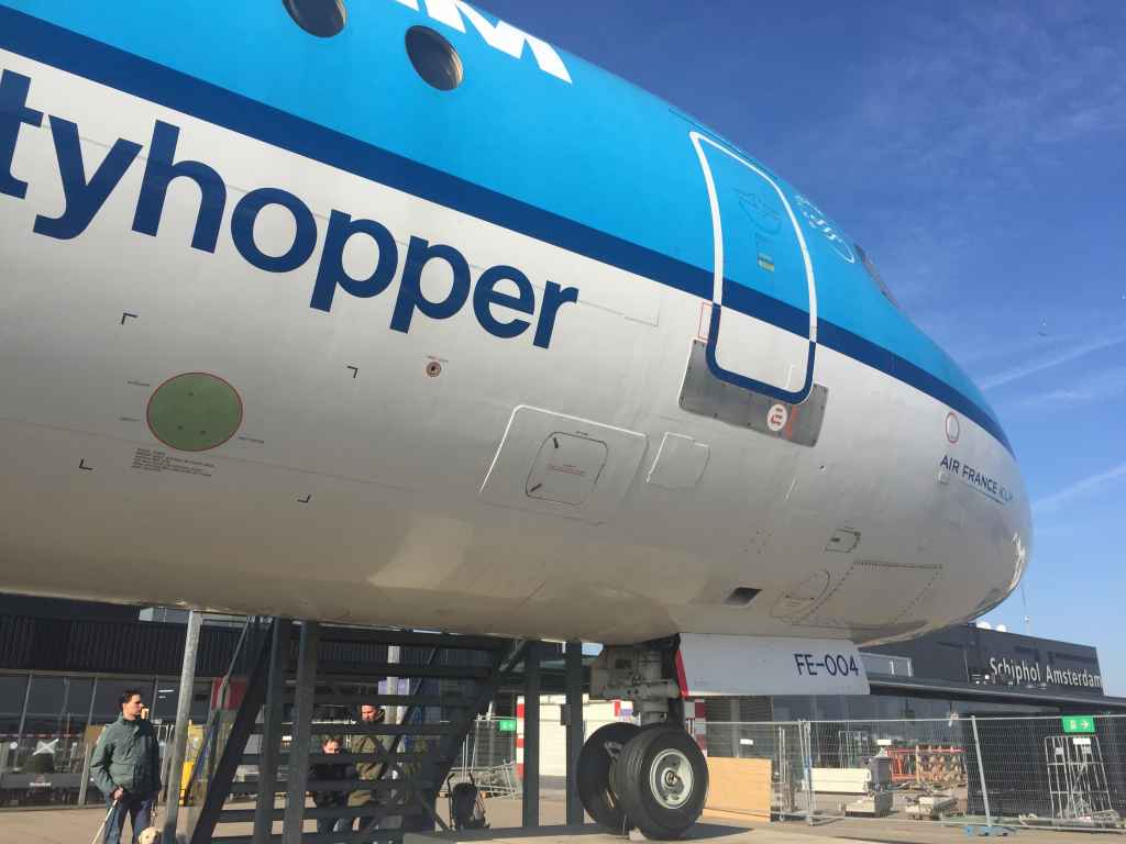 KLM Fokker 100 on display on top of the observation deck at Amsterdam Schiphol Airport.