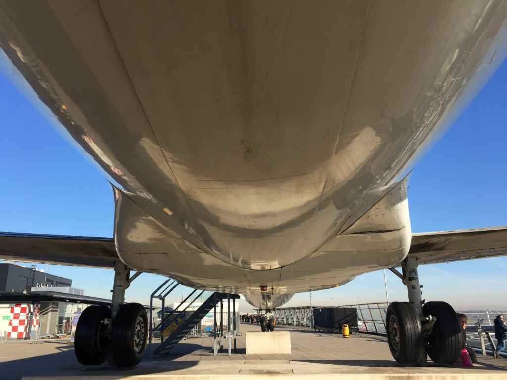Nice under belly view of the KLM Fokker 100 that sits atop the observation deck at Amsterdam Schiphol airport. You can even go inside the Fokker 100 to take a seat or view the flightdeck.