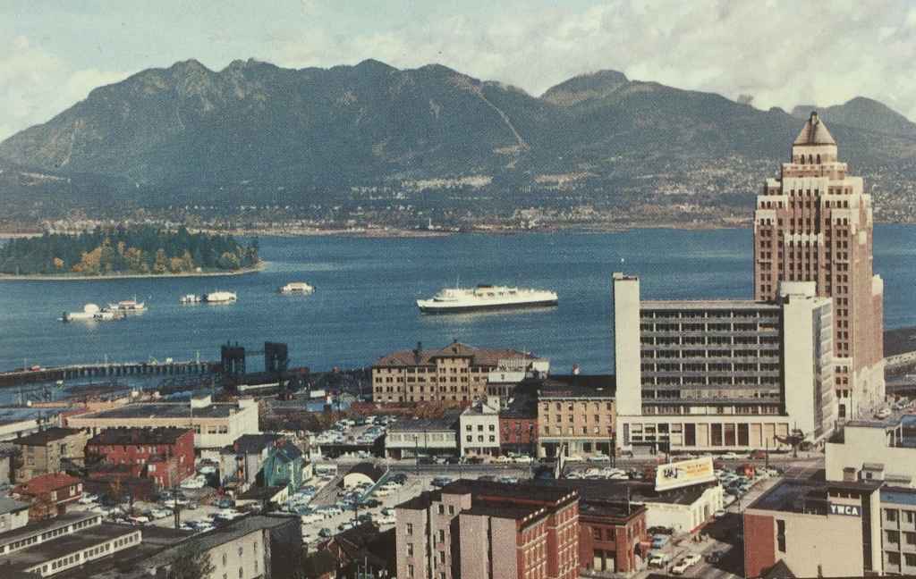 Another view of the Customs and Marine Building on the waterfront at the north end of Vancouver's Burrard Street, with the YMCA in the lower right of the image. Notice all the available ground level parking lots that were available back then. (Kodachrome Postcard published by The Coast Publishing Company, Vancouver, Canada.)